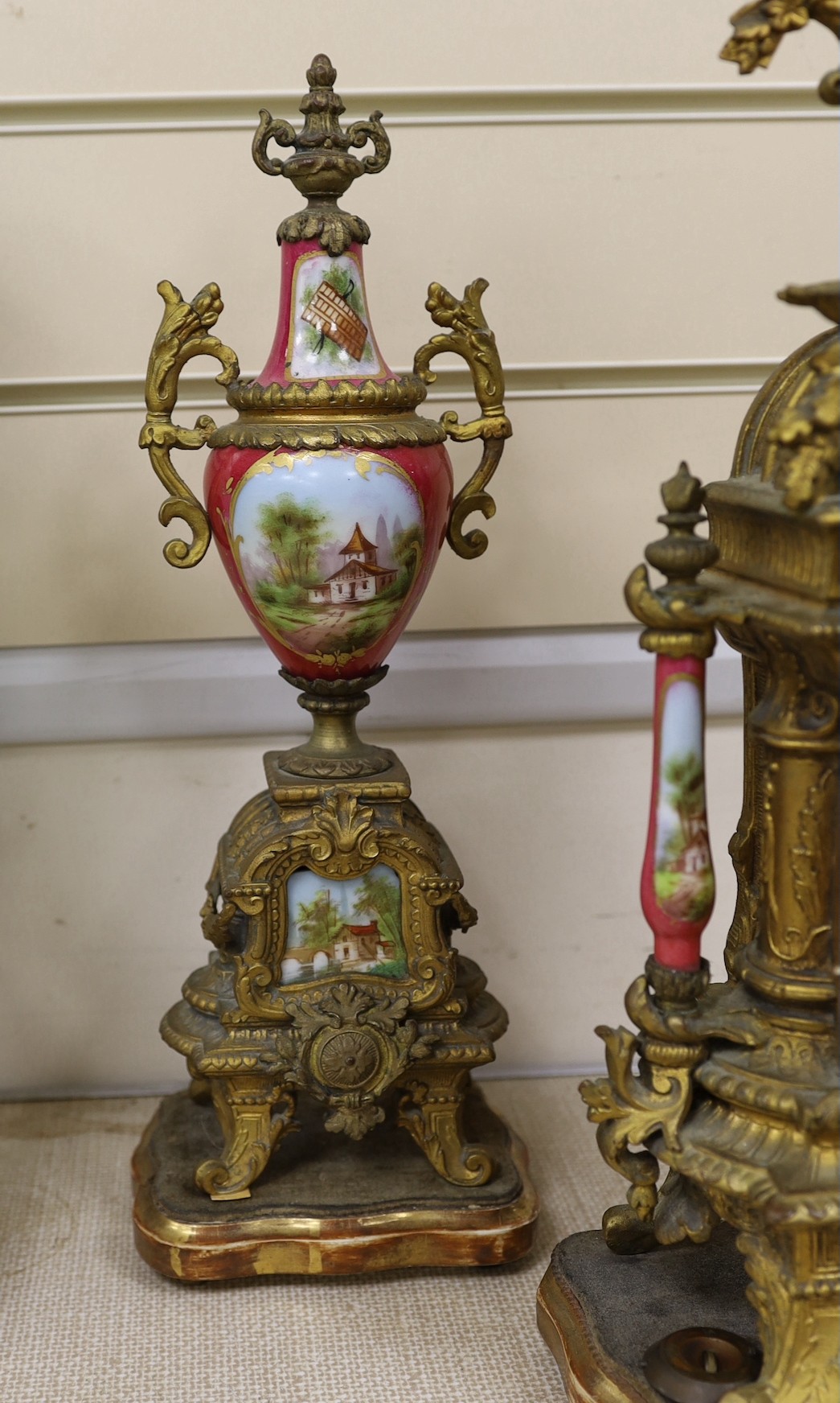 A 19th century Louis XV style gilt metal and porcelain mounted three piece clock garniture, clock 45cms high